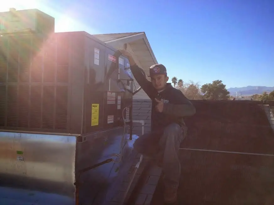 HVAC technician performing HVAC Inspection on a rooftop unit in Hybla Valley